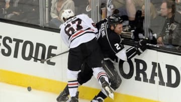 June 4, 2013; Los Angeles, CA, USA; Los Angeles Kings defenseman Matt Greene (2) is hit against the boards by Chicago Blackhawks center Michael Frolik (67) during the third period in game three of the Western Conference finals of the 2013 Stanley Cup Playoffs at the Staples Center. Mandatory Credit: Jayne Kamin-Oncea-USA TODAY Sports