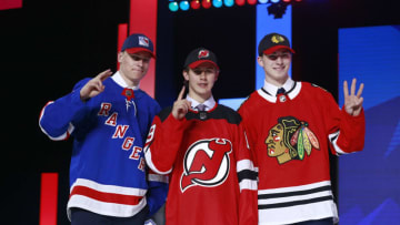 VANCOUVER, BRITISH COLUMBIA - JUNE 21: (L-R) Kaapo Kakko, second overall pick by the New York Rangers, Jack Hughes, first overall pick by the New Jersey Devils, and Kirby Dach, third overall pick by the Chicago Blackhawks, hold up their fingers of their pick order in front of the stage during the first round of the 2019 NHL Draft at Rogers Arena on June 21, 2019 in Vancouver, Canada. (Photo by Jeff Vinnick/NHLI via Getty Images)