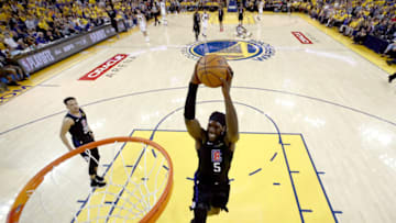 OAKLAND, CALIFORNIA - APRIL 13: Montrezl Harrell #5 of the LA Clippers goes up for a dunk against the Golden State Warriors during Game One of the first round of the 2019 NBA Western Conference Playoffs at ORACLE Arena on April 13, 2019 in Oakland, California. NOTE TO USER: User expressly acknowledges and agrees that, by downloading and or using this photograph, User is consenting to the terms and conditions of the Getty Images License Agreement. (Photo by Ezra Shaw/Getty Images)