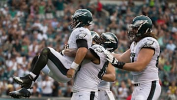 PHILADELPHIA, PA - AUGUST 11: Josh Andrews #68 of the Philadelphia Eagles picks up Chase Daniel #10 after he ran for a touchdown in the first quarter against the Tampa Bay Buccaneers at Lincoln Financial Field on August 11, 2016 in Philadelphia, Pennsylvania. The Eagles defeated the Buccaneers 17-9. (Photo by Mitchell Leff/Getty Images)
