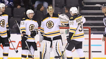 Mar 26, 2016; Toronto, Ontario, CAN; Boston Bruins goalie Tuukka Rask (40) celebrates their victory with left wing Brad Marchand (63) and center Patrice Bergeron (37) against the Toronto Maple Leafs at Air Canada Centre. The Bruins beat the Maple Leafs 3-1. Mandatory Credit: Tom Szczerbowski-USA TODAY Sports