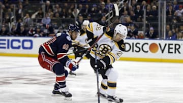Oct 26, 2016; New York, NY, USA; Boston Bruins defenseman John-Michael Liles (26) battles for the puck with New York Rangers right wing Michael Grabner (40) during the second period at Madison Square Garden. Mandatory Credit: Adam Hunger-USA TODAY Sports