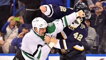 Dec 12, 2015; St. Louis, MO, USA; Dallas Stars left wing Jamie Benn (14) and St. Louis Blues center David Backes (42) fight during the first period at Scottrade Center. Mandatory Credit: Jasen Vinlove-USA TODAY Sports