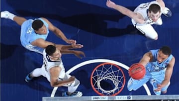 Feb 8, 2014; South Bend, IN, USA; North Carolina Tar Heels guard Marcus Paige (5) lays the ball in against Notre Dame Fighting Irish center Garrick Sherman (11) at the Joyce Center. North Carolina defeats Notre Dame 73-62. Mandatory Credit: Brian Spurlock-USA TODAY Sports
