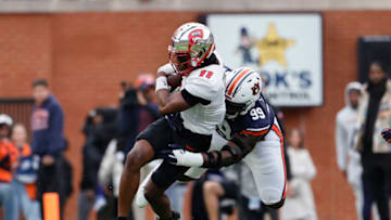 Auburn footballNov 19, 2022; Auburn, Alabama, USA; Auburn Tigers defensive lineman Jayson Jones (99) tackles Western Kentucky Hilltoppers wide receiver Malachi Corley (11) during the first quarter at Jordan-Hare Stadium. Mandatory Credit: John Reed-USA TODAY Sports