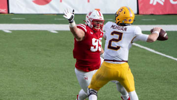 Dec 12, 2020; Lincoln, Nebraska, USA; Minnesota Golden Gophers quarterback Tanner Morgan (2) throws a pass against Nebraska Cornhuskers lineman Ty Robinson (99) during the fourth quarter at Memorial Stadium. Mandatory Credit: Dylan Widger-USA TODAY Sports
