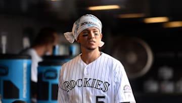 Jun 26, 2016; Denver, CO, USA; Colorado Rockies right fielder Carlos Gonzalez (5) walks the dugout during the ninth inning against the Arizona Diamondbacks at Coors Field. The Rockies won 9-7. Mandatory Credit: Ron Chenoy-USA TODAY Sports