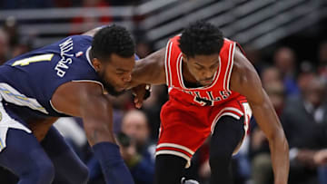 CHICAGO, IL - MARCH 21: Paul Millsap #4 of the Denver Nuggets and Justin Holiday #7 of the Chicago Bulls battle for a loose ball at the United Center on March 21, 2018 in Chicago, Illinois. The Nuggets defeated the Bulls 135-102. NOTE TO USER: User expressly acknowledges and agrees that, by downloading and or using this photograph, User is consenting to the terms and conditions of the Getty Images License Agreement. (Photo by Jonathan Daniel/Getty Images)