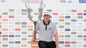 BEL OMBRE, MAURITIUS - DECEMBER 08: Rasmus Hojgaard of Denmark poses with the trophy after winning the Afrasia Bank Mauritius Open during Day Four of the Afrasia Bank Mauritius Open at Heritage Golf Club on December 08, 2019 in Bel Ombre, Mauritius. (Photo by Ross Kinnaird/Getty Images)