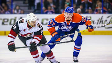 Mar 12, 2016; Edmonton, Alberta, CAN; Arizona Coyotes center Antoine Vermette (50) and Edmonton Oilers center Connor McDavid (97) battle for the puck during the first period at Rexall Place. Mandatory Credit: Sergei Belski-USA TODAY Sports