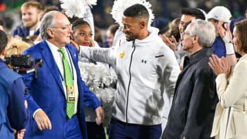 Nov 18, 2023; South Bend, Indiana, USA; Notre Dame Fighting Irish head coach Marcus Freeman, center, celebrates with Notre Dame Athletic Director Jack Swarbrick, left, and Notre Dame President Rev. John I. Jenkins, C.S.C. following the win over the Wake Forest Demon Deacons at Notre Dame Stadium. Both Swarbrick and Jenkins announced they will step down from their jobs in the coming months and it was the final home football game for both. Mandatory Credit: Matt Cashore-USA TODAY Sports