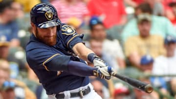 May 29, 2016; Milwaukee, WI, USA; Milwaukee Brewers catcher Jonathan Lucroy (20) drives in a run with a triple in the seventh inning against the Cincinnati Reds at Miller Park. Mandatory Credit: Benny Sieu-USA TODAY Sports