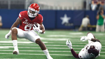 ARLINGTON, TX - SEPTEMBER 25: AJ Green #0 of the Arkansas Razorbacks eludes Edgerrin Cooper #45 of the Texas A&M Aggies before scoring a touchdown in the first half of the Southwest Classic at AT&T Stadium on September 25, 2021 in Arlington, Texas. (Photo by Ron Jenkins/Getty Images)