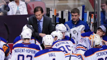 Apr 4, 2014; Glendale, AZ, USA; Edmonton Oilers head coach Dallas Eakins talks with his players during the third period against the Phoenix Coyotes at Jobing.com Arena. Mandatory Credit: Matt Kartozian-USA TODAY Sports