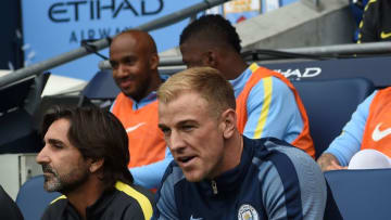 Manchester City's English goalkeeper Joe Hart (R) sits on the substitutes bench for the English Premier League football match between Manchester City and Sunderland at the Etihad Stadium in Manchester, north west England, on August 13, 2016.Manchester City manager Pep Guardiola dropped goalkeeper Joe Hart in favour of Willy Caballero for his opening Premier League game against Sunderland on August 13. / AFP / PAUL ELLIS / RESTRICTED TO EDITORIAL USE. No use with unauthorized audio, video, data, fixture lists, club/league logos or 'live' services. Online in-match use limited to 75 images, no video emulation. No use in betting, games or single club/league/player publications. / (Photo credit should read PAUL ELLIS/AFP/Getty Images)