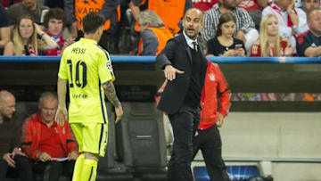Barcelona's Argentinian forward Lionel Messi (L) is to shake hands with Bayern Munich's Spanish head coach Pep Guardiola as he leaves the pitch at half time during the UEFA Champions League football match semi final FC Bayern Munich vs FC Barcelona in Munich on May 12, 2015.AFP PHOTO / ODD ANDERSEN (Photo credit should read ODD ANDERSEN/AFP/Getty Images)
