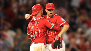 ANAHEIM, CALIFORNIA - JUNE 11: Jonathan Lucroy #20 and Hansel Robles #57 of the Los Angeles Angels of Anaheim celebrate after defeating the Los Angeles Dodgers 5-3 during a game at Angel Stadium of Anaheim on June 11, 2019 in Anaheim, California. (Photo by Sean M. Haffey/Getty Images)