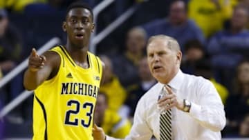 Jan 17, 2015; Ann Arbor, MI, USA; Michigan Wolverines head coach John Beilein talks to guard Caris LeVert (23) during the first half against the Northwestern Wildcats at Crisler Center. Mandatory Credit: Rick Osentoski-USA TODAY Sports