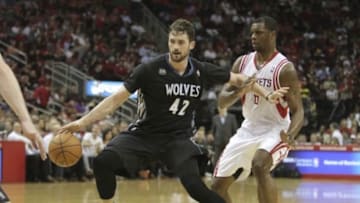 Mar 20, 2014; Houston, TX, USA; Minnesota Timberwolves forward Kevin Love (42) drives to the basket against Houston Rockets forward Terrence Jones (6) during the third quarter at Toyota Center. Mandatory Credit: Andrew Richardson-USA TODAY Sports