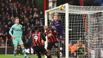 Arsenal's German goalkeeper Bernd Leno (R) dives to push the ball away from his goal during the English Premier League football match between Bournemouth and Arsenal at the Vitality Stadium in Bournemouth, southern England on November 25, 2018. (Photo by Glyn KIRK / AFP) / RESTRICTED TO EDITORIAL USE. No use with unauthorized audio, video, data, fixture lists, club/league logos or 'live' services. Online in-match use limited to 120 images. An additional 40 images may be used in extra time. No video emulation. Social media in-match use limited to 120 images. An additional 40 images may be used in extra time. No use in betting publications, games or single club/league/player publications. / (Photo credit should read GLYN KIRK/AFP/Getty Images)