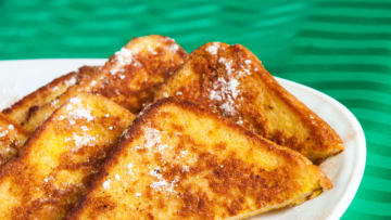 TORONTO, ONTARIO, CANADA - 2013/03/11: Plate of French toast. Five slices of French toast sit on a white plate, dusted in powdered sugar. The plate is set on top of a green tablecloth. (Photo by Roberto Machado Noa/LightRocket via Getty Images)