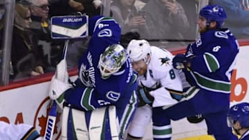Mar 29, 2016; Vancouver, British Columbia, CAN; Vancouver Canucks goaltender Jacob Markstrom (25) battles for the puck with San Jose Sharks forward Joe Pavelski (8) behind the net during the second period at Rogers Arena. Mandatory Credit: Anne-Marie Sorvin-USA TODAY Sports