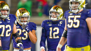 Nov 7, 2020; South Bend, Indiana, USA; Notre Dame Fighting Irish quarterback Ian Book (12) walks to the line of scrimmage in the first quarter against the Clemson Tigers at Notre Dame Stadium. Notre Dame defeated Clemson 47-40 in two overtimes. Mandatory Credit: Matt Cashore-USA TODAY Sports
