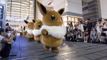 YOKOHAMA, JAPAN - AUGUST 08: Performers dressed as Eevee, a character from the Pokémon media franchise managed by The Pokémon Company, march during the Pikachu Outbreak event at night on August 8, 2019 in Yokohama, Japan. A total of 2,000 Pikachus appear at the city's landmarks in the Minato Mirai area aiming to attract visitors and tourists to the city. The event will be held through August 12. (Photo by Tomohiro Ohsumi/Getty Images)