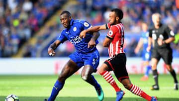 LEICESTER, ENGLAND - OCTOBER 02: Wes Morgan of Leicester City (L) and Nathan Redmond of Southampton (R) battle for possession during the Premier League match between Leicester City and Southampton at The King Power Stadium on October 2, 2016 in Leicester, England. (Photo by Michael Regan/Getty Images)