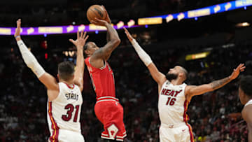 Chicago Bulls forward DeMar DeRozan (11) goes up for a shot over Miami Heat forward Caleb Martin (16) as guard Max Strus (31) looks on(Jim Rassol-USA TODAY Sports)
