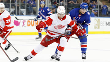 NEW YORK, NEW YORK - APRIL 16: Filip Zadina #11 of the Detroit Red Wings chases the puck against Ryan Strome #16 of the New York Rangers during the third period at Madison Square Garden on April 16, 2022 in New York City. The Rangers won 4-0. (Photo by Sarah Stier/Getty Images)