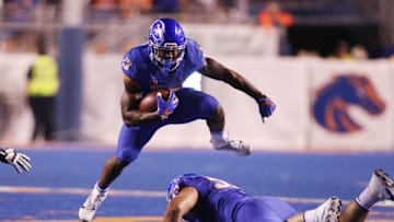 Sep 10, 2016; Boise, ID, USA; Boise State Broncos running back Jeremy McNichols (13) leaps over offensive lineman Mason Hampton (59) during the second half at Albertsons Stadium against Washington State Cougars. Boise State defeats Washington State 31-28. Mandatory Credit: Brian Losness-USA TODAY Sports