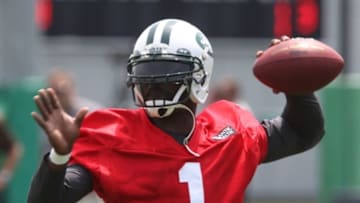 Jun 17, 2014; Florham Park, NJ, USA; New York Jets quarterback Michael Vick (1) throws a pass during minicamp at Atlantic Health Training Center. Mandatory Credit: Noah K. Murray-USA TODAY Sports