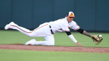 BALTIMORE, MD - JULY 09: Manny Machado #13 of the Baltimore Orioles can not get a ball hit by Miguel Andujar #41 (not pictured) of the New York Yankees in the ninth inning during a game one of a doubleheader baseball game at Oriole Park at Camden Yards on July 9, 2018 in Baltimore, Maryland. (Photo by Mitchell Layton/Getty Images)
