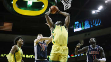 EUGENE, OREGON - JANUARY 14: N'Faly Dante #1 of the Oregon Ducks goes up for a dunk agaisnt Azuolas Tubelis #10 of the Arizona Wildcats during the first half at Matthew Knight Arena on January 14, 2023 in Eugene, Oregon. (Photo by Soobum Im/Getty Images)