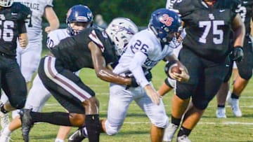 White House Heritage's Colby Hulsey (26) looks to gain ground against the defense of East Robertson's Taylor Groves (3) Syndication: Nashville