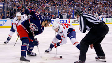 COLUMBUS, OH - APRIL 23: Linesman Pierre Racicot #65 drops the puck for Alexander Wennberg #10 of the Columbus Blue Jackets and Evgeny Kuznetsov #92 of the Washington Capitals in Game Six of the Eastern Conference First Round during the 2018 NHL Stanley Cup Playoffs on April 23, 2018 at Nationwide Arena in Columbus, Ohio. Washington defeated Columbus 6-3 to win the series 4-2. (Photo by Kirk Irwin/Getty Images) *** Local Caption *** Pierre Racicot;Alexander Wennberg;Evgeny Kuznetsov