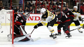 RALEIGH, NORTH CAROLINA - MAY 14: Curtis McElhinney #35 of the Carolina Hurricanes gives up a goal to Brad Marchand #63 of the Boston Bruins during the second period in Game Three of the Eastern Conference Finals during the 2019 NHL Stanley Cup Playoffs at PNC Arena on May 14, 2019 in Raleigh, North Carolina. (Photo by Bruce Bennett/Getty Images)
