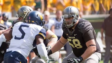 Oct 17, 2015; Waco, TX, USA; Baylor Bears offensive tackle Spencer Drango (58) blocks West Virginia Mountaineers cornerback Nana Kyeremeh (5) during the game at McLane Stadium. The Bears defeat the Mountaineers 62-38. Mandatory Credit: Jerome Miron-USA TODAY Sports