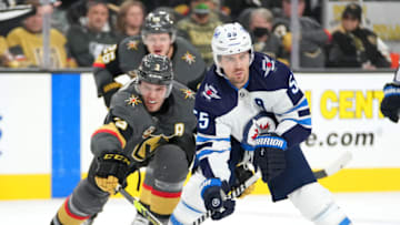 Jan 2, 2022; Las Vegas, Nevada, USA; Vegas Golden Knights defenseman Brayden McNabb (3) reaches to poke the puck away from Winnipeg Jets center Mark Scheifele (55) during the third period at T-Mobile Arena. Mandatory Credit: Stephen R. Sylvanie-USA TODAY Sports