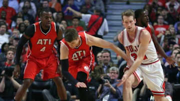 Apr 15, 2015; Chicago, IL, USA; Atlanta Hawks guard Kyle Korver (26) and Chicago Bulls forward Mike Dunleavy (34) play for the ball during the first quarter at the United Center. Mandatory Credit: Dennis Wierzbicki-USA TODAY Sports