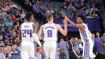 SACRAMENTO, CA - OCTOBER 2: De'Aaron Fox #5 of the Sacramento Kings give high fives to teammates during the preseason game against the San Antonio Spurs on October 2, 2017 at Golden 1 Center in Sacramento, California. NOTE TO USER: User expressly acknowledges and agrees that, by downloading and or using this Photograph, user is consenting to the terms and conditions of the Getty Images License Agreement. Mandatory Copyright Notice: Copyright 2017 NBAE (Photo by Rocky Widner/NBAE via Getty Images)