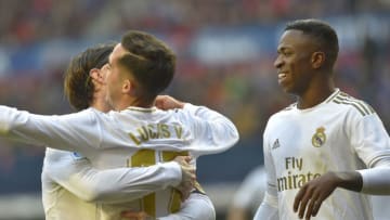 Real Madrid's Spanish forward Lucas Vazquez celebrates with teammates Real Madrid's Spanish defender Sergio Ramos (L) and Real Madrid's Brazilian forward Vinicius Junior (R) after scoring his team's third goal during the Spanish league football match between CA Osasuna and Real Madrid CF at El Sadar stadium in Pamplona on February 9, 2020. (Photo by ANDER GILLENEA / AFP) (Photo by ANDER GILLENEA/AFP via Getty Images)