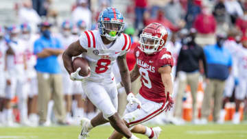 FAYETTEVILLE, AR - OCTOBER 17: Elijah Moore #8 of the Mississippi Rebels runs past Greg Brooks Jr. #9 of the Arkansas Razorbacks at Razorback Stadium on October 17, 2020 in Fayetteville, Arkansas. The Razorbacks defeated the Rebels 33-21. (Photo by Wesley Hitt/Getty Images)