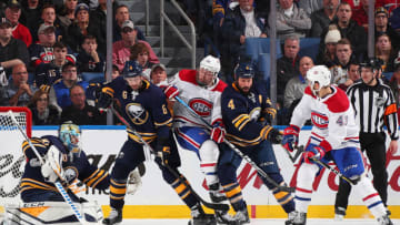 BUFFALO, NY - NOVEMBER 23: Marco Scandella #6, Carter Hutton #40 and Zach Bogosian #4 of the Buffalo Sabres defend against Nicolas Deslauriers #20 and Michael Chaput #43 of the Montreal Canadiens on November 23, 2018 at KeyBank Center in Buffalo, New York. (Photo by Bill Wippert/NHLI via Getty Images)