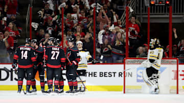 RALEIGH, NORTH CAROLINA - MAY 14: Calvin de Haan #44 of the Carolina Hurricanes celebrates with his teammates after scoring a goal on Tuukka Rask #40 of the Boston Bruins during the second period in Game Three of the Eastern Conference Finals during the 2019 NHL Stanley Cup Playoffs at PNC Arena on May 14, 2019 in Raleigh, North Carolina. (Photo by Bruce Bennett/Getty Images)