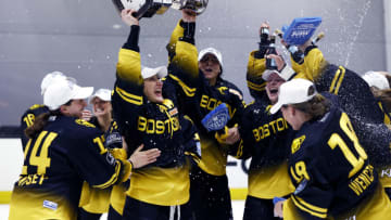 BOSTON, MASSACHUSETTS - MARCH 27: Kaleigh Fratkin #13 of Boston Pride raises the Isobel Cup trophy surrounded by teammates after the Boston Pride deafeat the Minnesota Whitecaps 4-3 in the NWHL Isobel Cup Championship at Warrior Ice Arena on March 27, 2021 in Boston, Massachusetts. (Photo by Maddie Meyer/Getty Images)