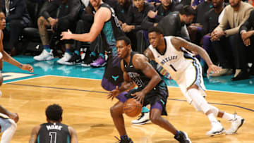 CHARLOTTE, NC - MARCH 22: Treveon Graham #21 of the Charlotte Hornets handles the ball against Jarell Martin #1 of the Memphis Grizzlies on March 22, 2018 at Spectrum Center in Charlotte, North Carolina. NOTE TO USER: User expressly acknowledges and agrees that, by downloading and or using this photograph, User is consenting to the terms and conditions of the Getty Images License Agreement. Mandatory Copyright Notice: Copyright 2018 NBAE (Photo by Brock Williams-Smith/NBAE via Getty Images)