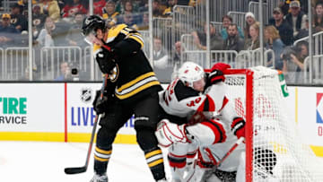 BOSTON, MA - OCTOBER 12: Boston Bruins right wing Brett Ritchie (18) tries to get the handle on the loose puck as New Jersey Devils defenseman Sami Vatanen (45) crashes into New Jersey Devils goalie Cory Schneider (35) during a game between the Boston Bruins and the New Jersey Devils on October 12, 2019, at TD Garden in Boston, Massachusetts. (Photo by Fred Kfoury III/Icon Sportswire via Getty Images)