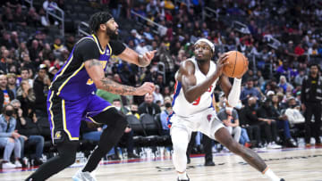 DETROIT, MICHIGAN - NOVEMBER 21: Jerami Grant #9 of the Detroit Pistons drives to the basket against Anthony Davis #3 of the Los Angeles Lakers during the fourth quarter of the game at Little Caesars Arena on November 21, 2021 in Detroit, Michigan. NOTE TO USER: User expressly acknowledges and agrees that, by downloading and or using this photograph, User is consenting to the terms and conditions of the Getty Images License Agreement. (Photo by Nic Antaya/Getty Images)